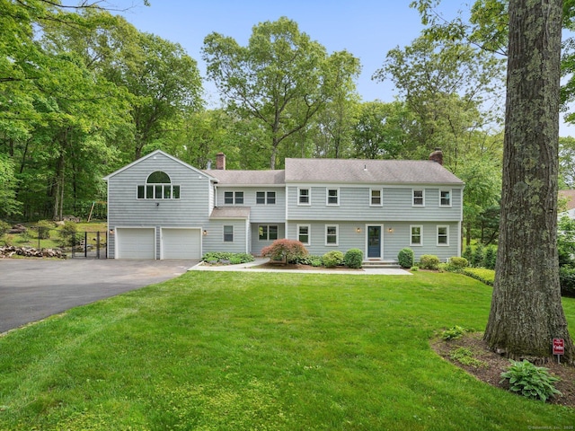 37 Saint Johns Rd, Wilton, CT 06897 - view of front of property with a chimney, a garage, driveway, and a front lawn
