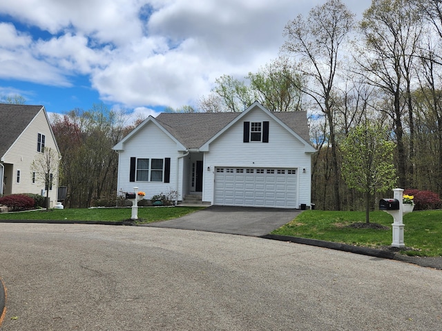 view of front of home with a garage, a shingled roof, a front yard, and aphalt driveway
