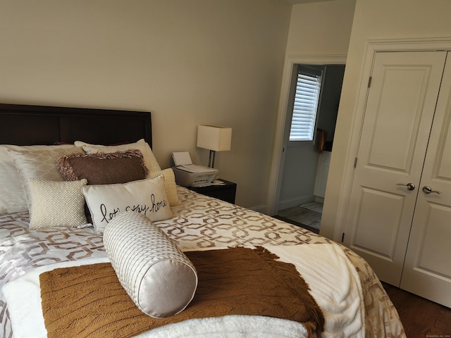bedroom with a closet and baseboards