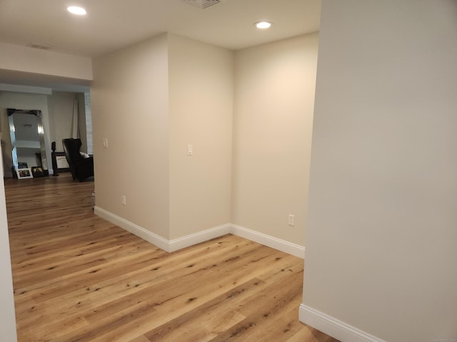 unfurnished room with baseboards, recessed lighting, light wood-style flooring, and visible vents