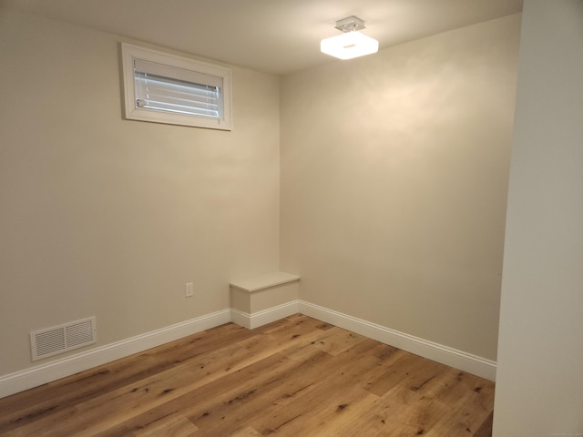empty room with visible vents, baseboards, and light wood-type flooring