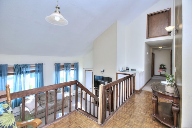 hallway featuring vaulted ceiling and an upstairs landing