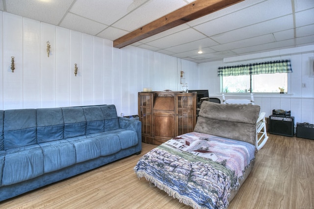 living room featuring a paneled ceiling and wood finished floors