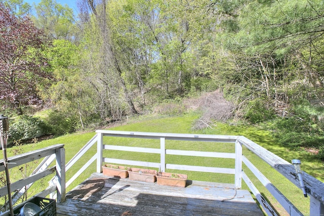 wooden deck with a lawn