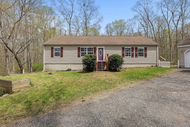 view of front of home featuring a garage and a front lawn