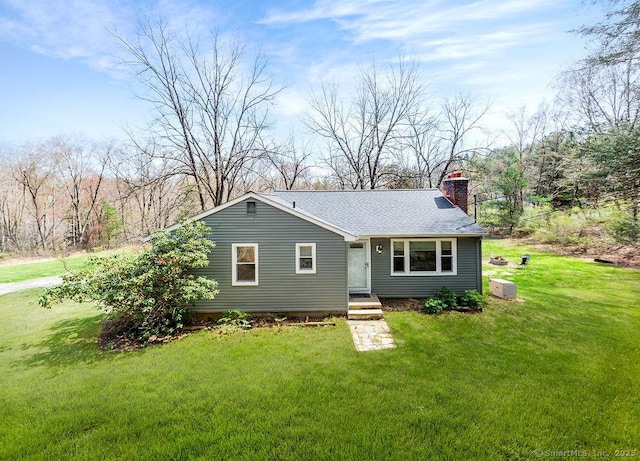 38 Black Bridge Rd, Newtown, CT 06482 - view of front of home with roof with shingles, a chimney, and a front yard