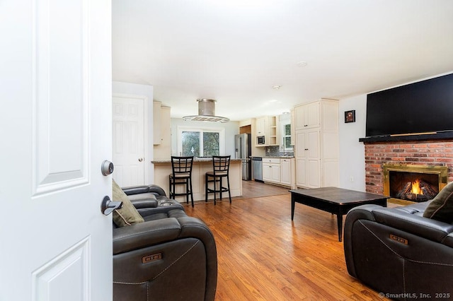 38 Black Bridge Rd, Newtown, CT 06482 - living area with a brick fireplace and light wood-type flooring
