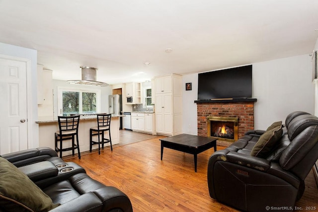 38 Black Bridge Rd, Newtown, CT 06482 - living area featuring light wood finished floors and a fireplace