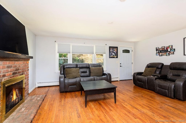 38 Black Bridge Rd, Newtown, CT 06482 - living area with baseboards, a baseboard heating unit, wood finished floors, and a brick fireplace