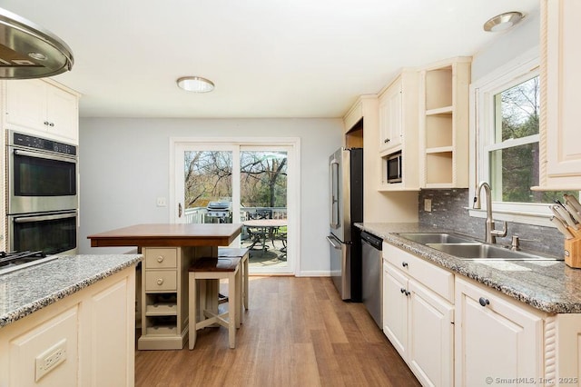 38 Black Bridge Rd, Newtown, CT 06482 - kitchen featuring a sink, light wood finished floors, appliances with stainless steel finishes, and a healthy amount of sunlight