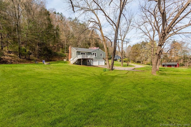 38 Black Bridge Rd, Newtown, CT 06482 - view of yard with stairway, an attached garage, driveway, and a wooden deck