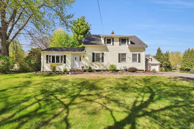 traditional-style house with a chimney and a front yard