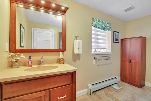 bathroom with a baseboard radiator, baseboards, visible vents, tile patterned flooring, and vanity