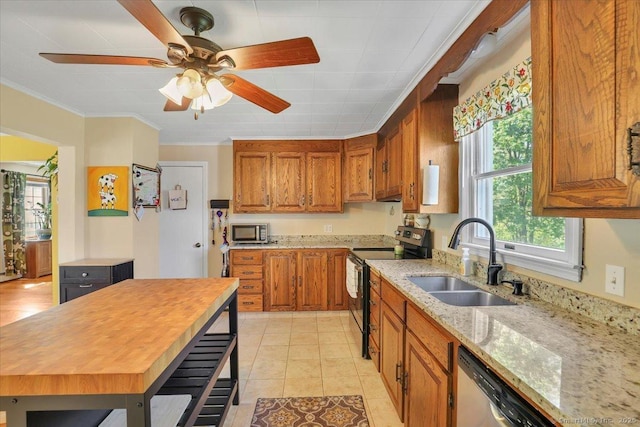kitchen featuring appliances with stainless steel finishes, brown cabinets, ornamental molding, and a sink