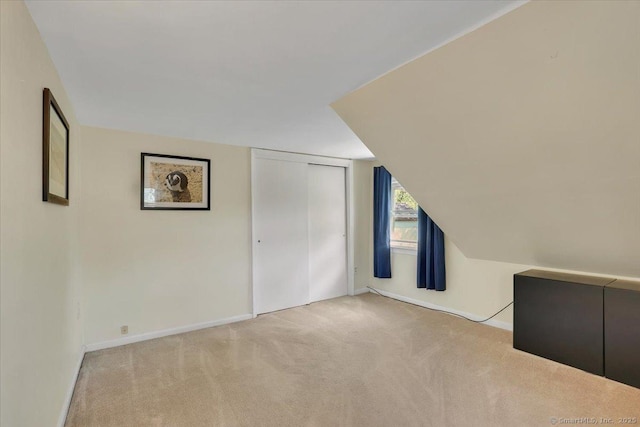 bonus room featuring carpet and baseboards