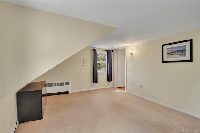 additional living space featuring radiator, baseboards, and carpet flooring