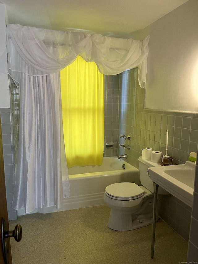 bathroom featuring tile walls, shower / bath combo with shower curtain, and toilet