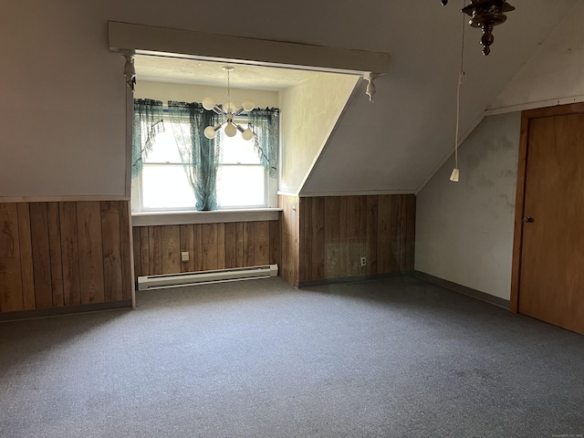 bonus room with wood walls, an inviting chandelier, wainscoting, and a baseboard radiator