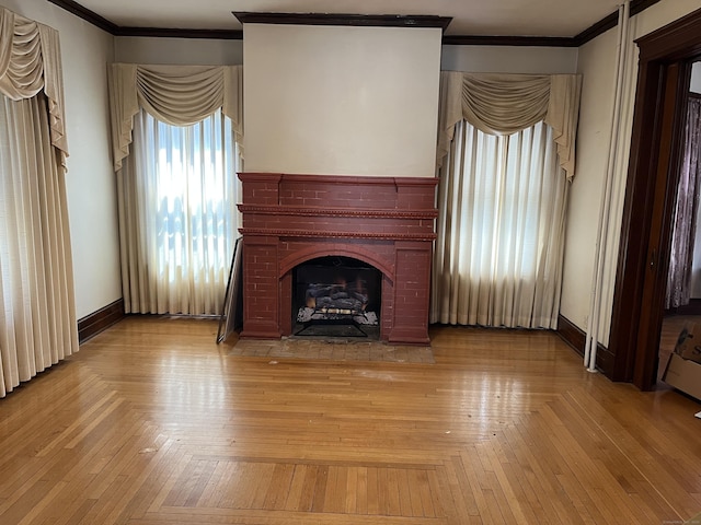 unfurnished living room with baseboards, ornamental molding, and a fireplace