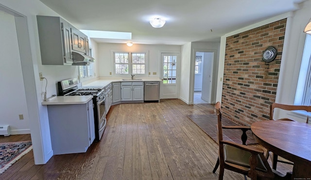 32 Great Hill Pond Rd, Portland, CT 06480 - kitchen with dark wood-style flooring, a sink, light countertops, stainless steel appliances, and a skylight