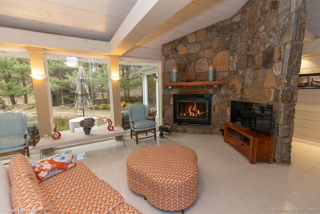 living room with tile patterned flooring, wood ceiling, and an outdoor stone fireplace