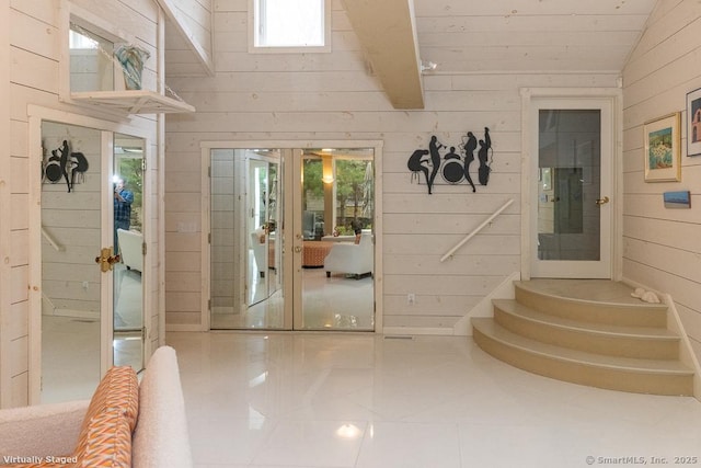 interior space with wood walls and vaulted ceiling