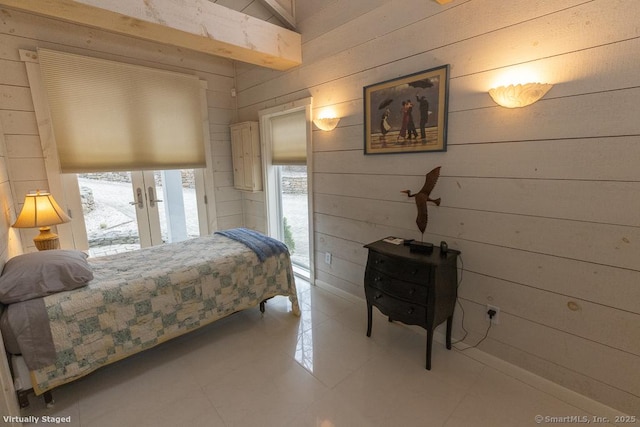 tiled bedroom with wooden walls and french doors