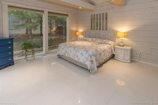 bedroom with wood walls and access to exterior