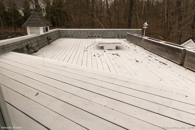 deck featuring a shed