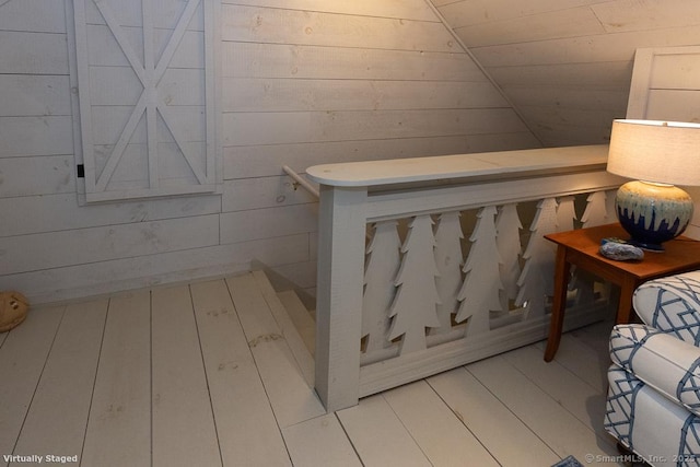 interior space featuring wooden walls and wood finished floors