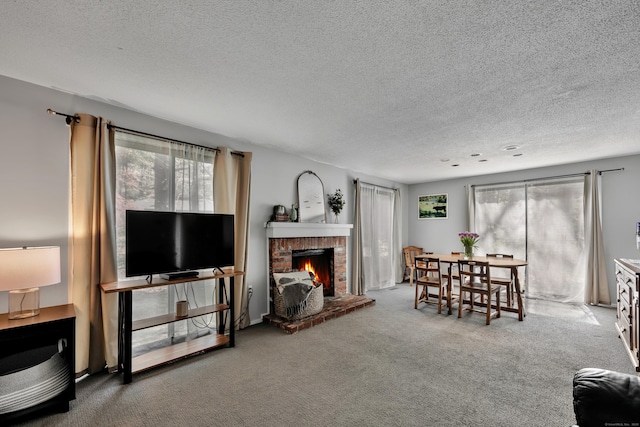 carpeted living room with a fireplace and a textured ceiling