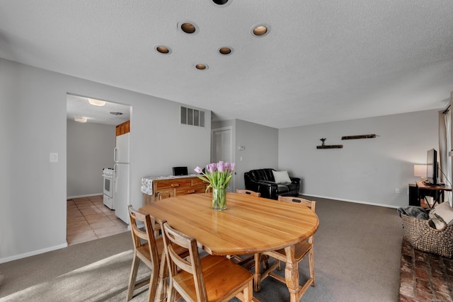 dining space with light colored carpet, a textured ceiling, recessed lighting, baseboards, and visible vents