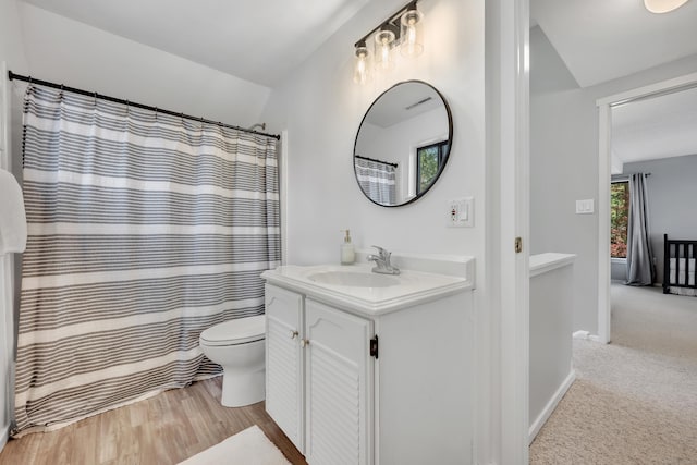 bathroom with vanity, baseboards, toilet, and visible vents