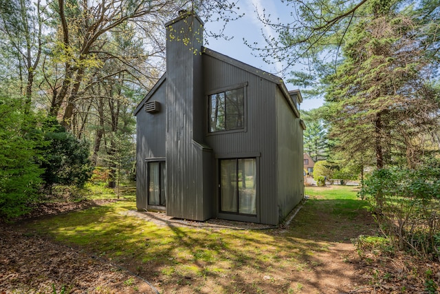 rear view of house featuring a yard