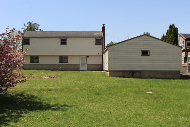 rear view of house with a lawn