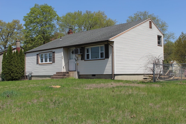 view of front of house with fence, a chimney, roof with shingles, and a wall unit AC