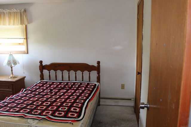 carpeted bedroom with a baseboard radiator