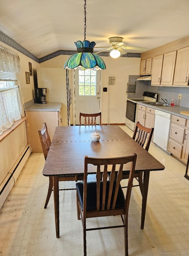 dining area with vaulted ceiling, light floors, a ceiling fan, and a baseboard heating unit