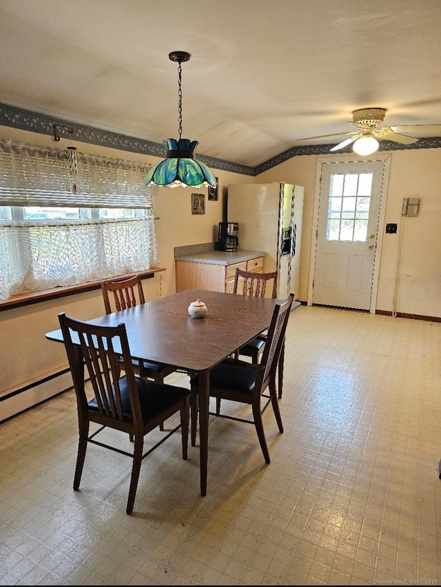 dining room with baseboards, ceiling fan, and vaulted ceiling