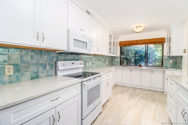 920 Heritage Vlg Unit A, Southbury, CT 06488 - kitchen with white appliances, white cabinets, backsplash, and glass insert cabinets