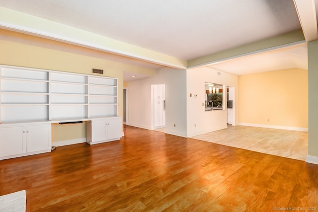 920 Heritage Vlg Unit A, Southbury, CT 06488 - unfurnished living room featuring light wood finished floors and baseboards