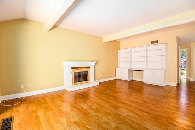 920 Heritage Vlg Unit A, Southbury, CT 06488 - unfurnished living room featuring wood finished floors and a glass covered fireplace