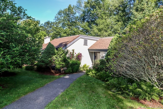 920 Heritage Vlg Unit A, Southbury, CT 06488 - view of front facade with a chimney, a front lawn, and stucco siding