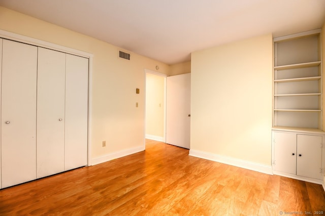 920 Heritage Vlg Unit A, Southbury, CT 06488 - unfurnished bedroom featuring light wood-style flooring and a closet