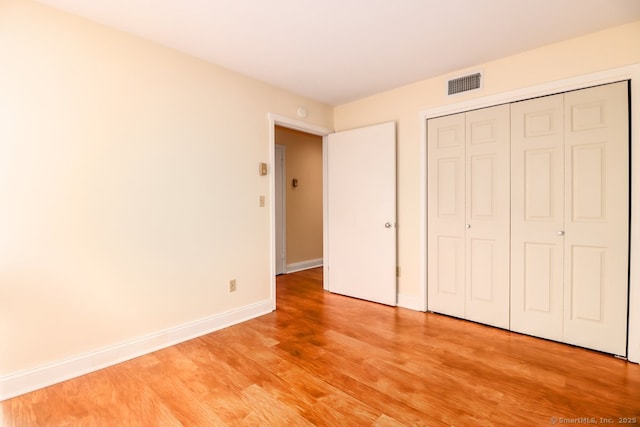 920 Heritage Vlg Unit A, Southbury, CT 06488 - unfurnished bedroom featuring light wood-style flooring and a closet