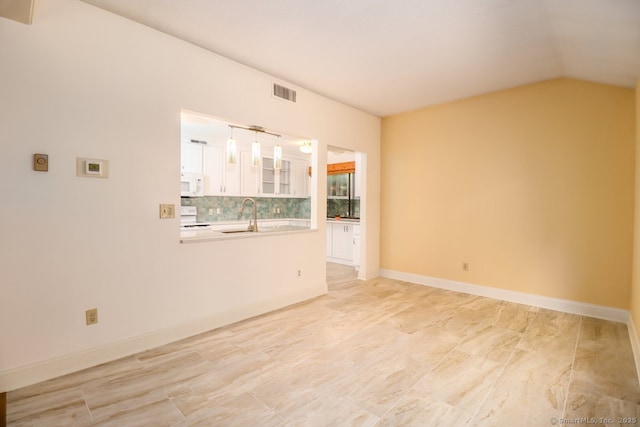 920 Heritage Vlg Unit A, Southbury, CT 06488 - empty room featuring a sink and vaulted ceiling