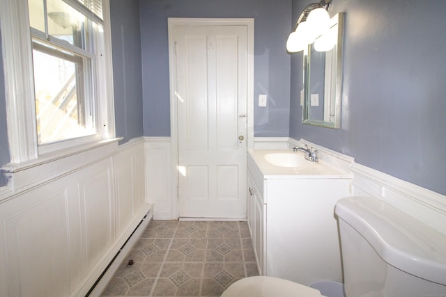 35 Clinton Ave, Middletown, CT 06457 - half bath with vanity, wainscoting, toilet, baseboard heating, and tile patterned floors