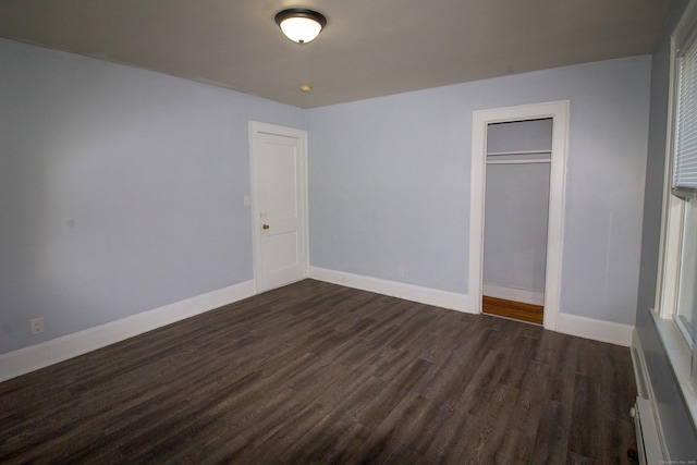 35 Clinton Ave, Middletown, CT 06457 - unfurnished bedroom with baseboards, dark wood finished floors, and a closet