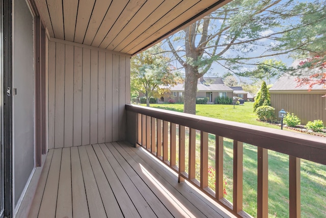 wooden deck with a lawn