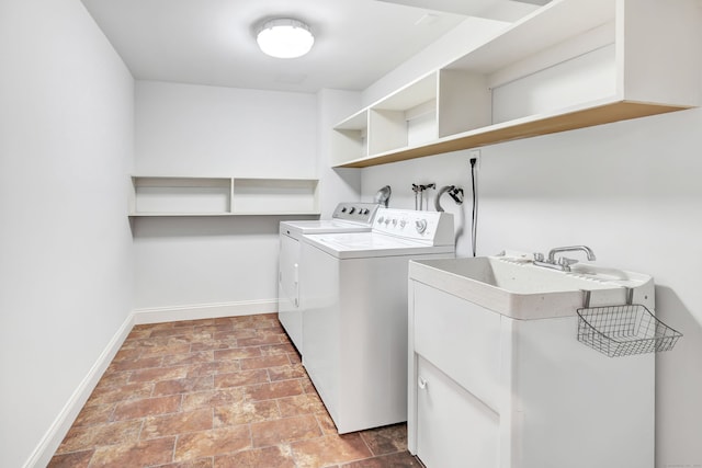 laundry room with independent washer and dryer, laundry area, a sink, and baseboards